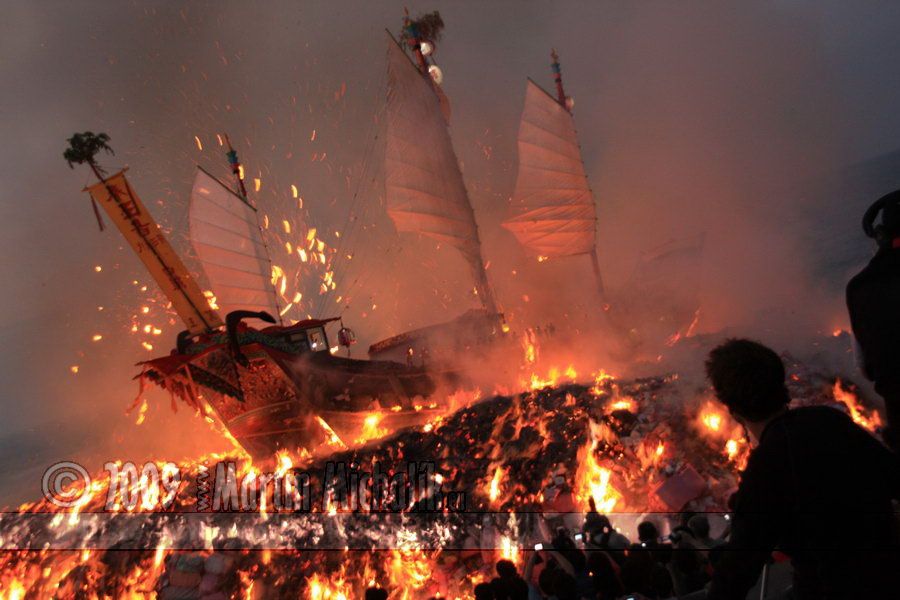 a man watching the boat burning